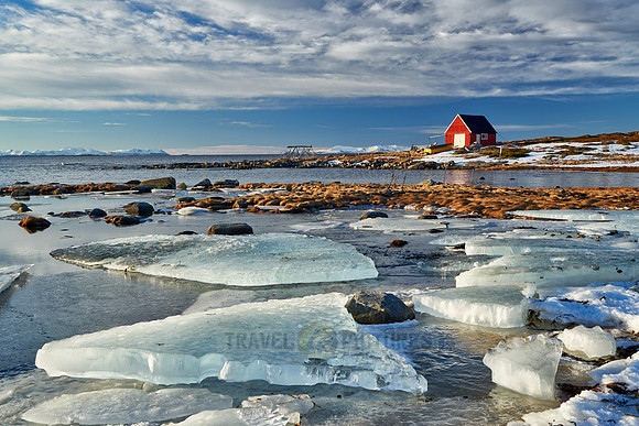 winter landscape with ice floes and typical red house