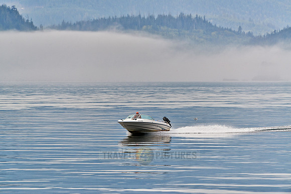 motorboat driving through the fog of Johnstone Strait|
