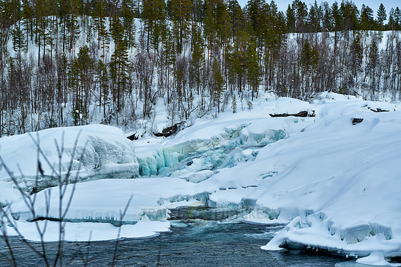 waterfall Malselvfossen covered with snow