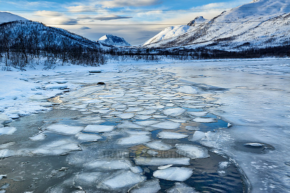 river with ice floes in winter landscape on Senja