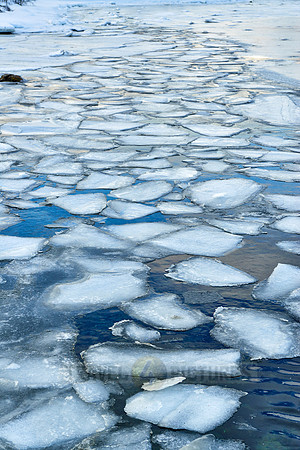 river with ice floes in winter landscape on Senja