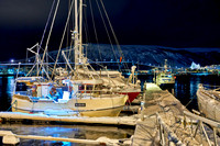 night shot of a snow covered vessel in harbour of Tromsø