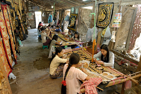 women stitching tapestries