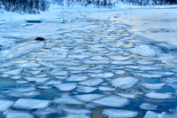 river with ice floes in winter landscape on Senja