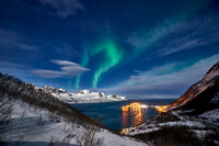 Aurora Borealis over winter landscape in fjord of Husøy