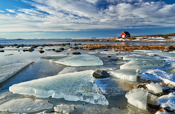 winter landscape with ice floes and typical red house