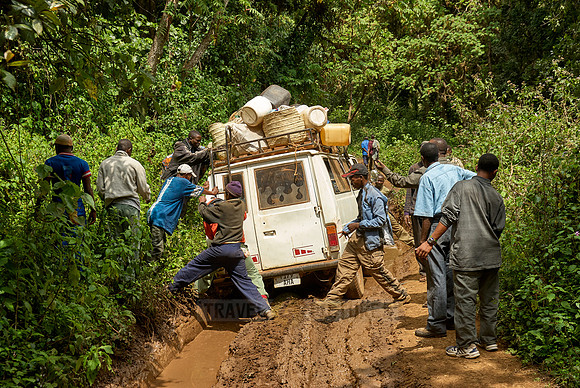 pushing Minibus across mud pool