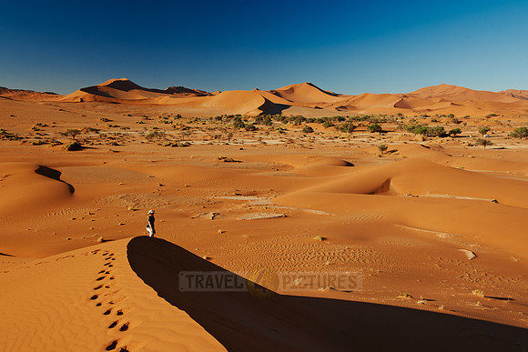 person on dune in desert landscape of Namib