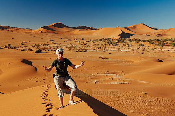 person on dune in desert landscape of Namib