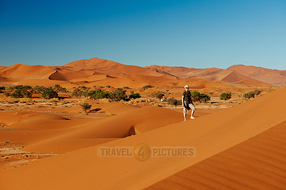 person on dune in desert landscape of Namib