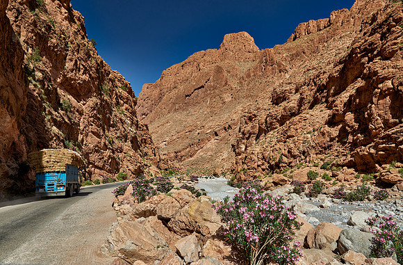 truck driving through upper part of Todra Gorge