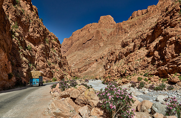 truck driving through upper part of Todra Gorge