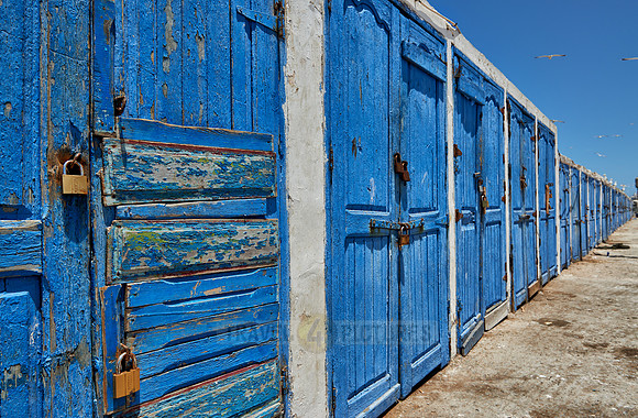 locked wooden blue doors in row from fishery equipment sheds