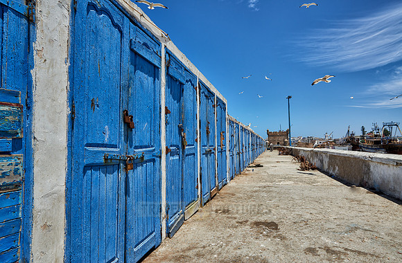 locked wooden blue doors in row from fishery equipment sheds