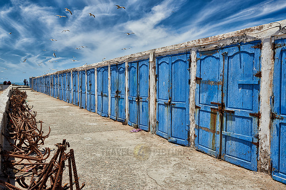 locked wooden blue doors in row from fishery equipment sheds