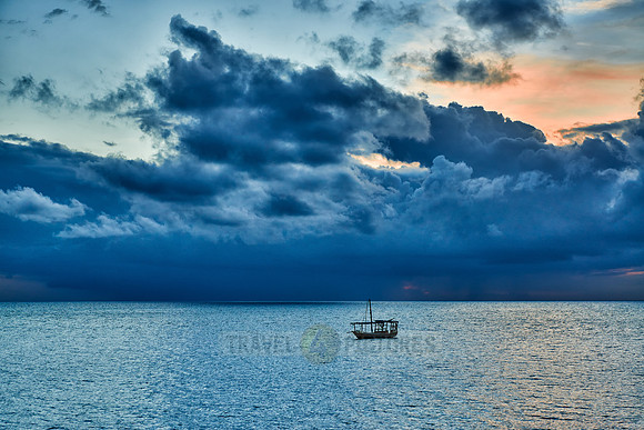 dhow swings in sea at sunset