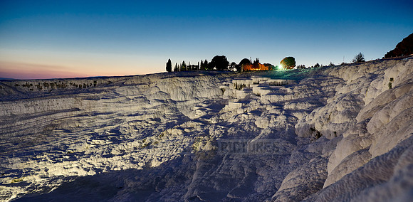 illuminated Pamukkale travertine terraces after sunset