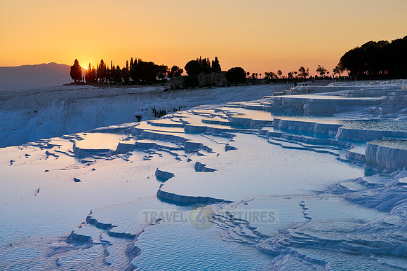 sunset behind Pamukkale travertine terraces