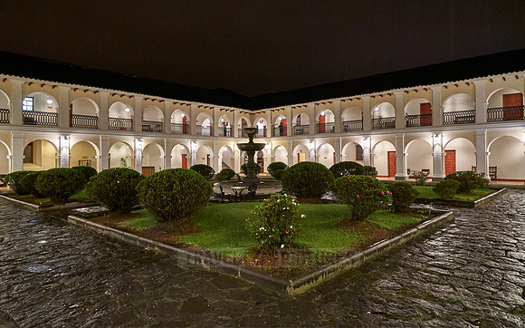 night shot of inner courtyard of Hotel Dann Monasterio