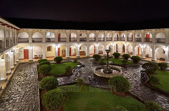 night shot of inner courtyard of Hotel Dann Monasterio