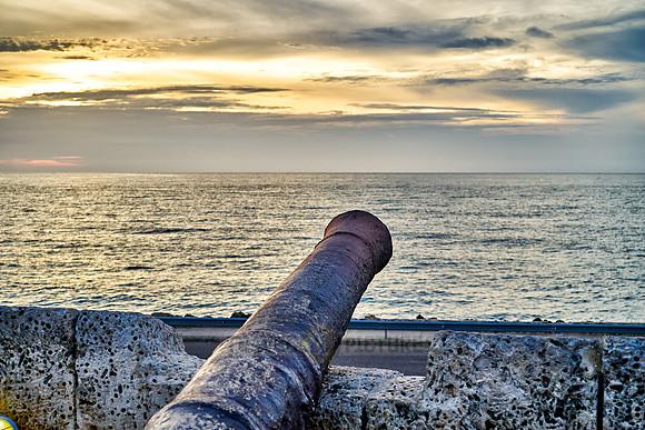cannon and sunset at Cafe del Mar