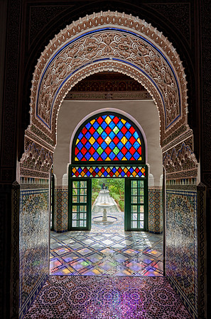 Light falls through colorful glass panes of the Bahia Palace