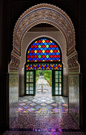 Light falls through colorful glass panes of the Bahia Palace