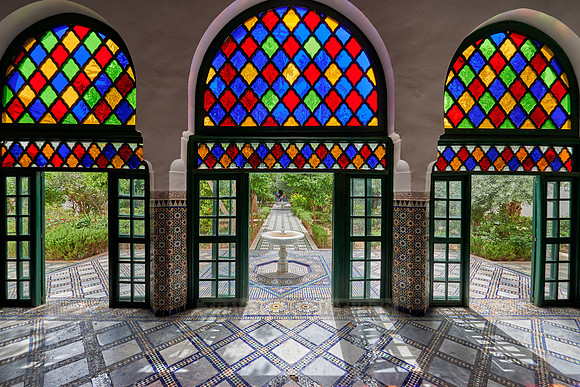 Light falls through colorful glass panes of the Bahia Palace