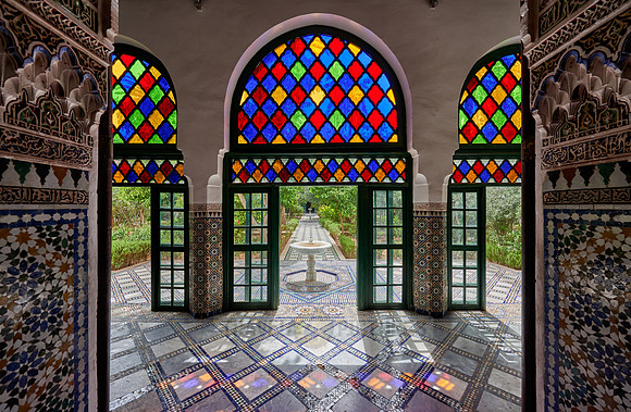 Light falls through colorful glass panes of the Bahia Palace