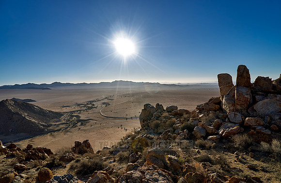 view from mountain on desert landscape with burning sun of farm Klein-Aus Vista