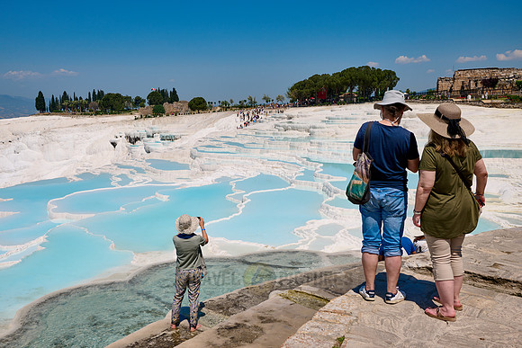 tourists in front of Pamukkale travertine terraces