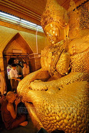 uddha with thick layer of golden leaves in Mahamuni Pagoda