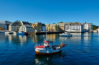 small fishing vessel in old harbor of Alesund