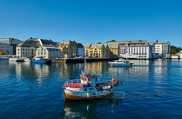 small fishing vessel in old harbor of Alesund