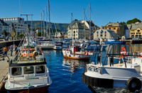 small fishing vessel in old harbor of Alesund