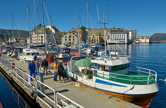 small fishing vessel in old harbor of Alesund