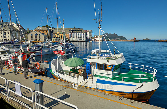 small fishing vessel in old harbor of Alesund