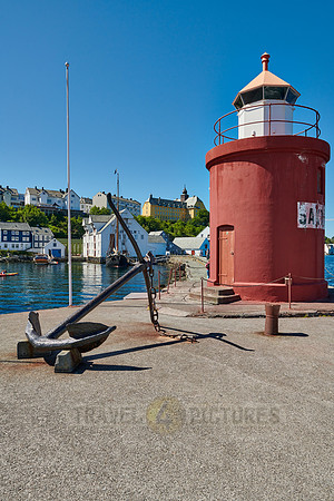 lighthouse and anchor  at entrance of old harbor