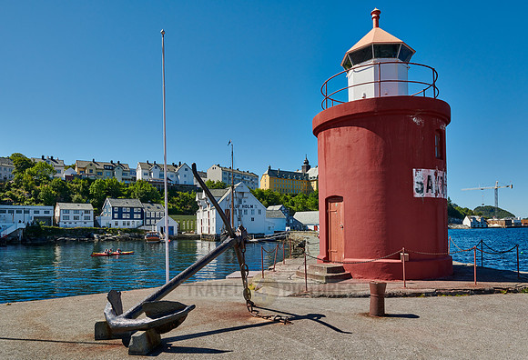 lighthouse and anchor  at entrance of old harbor