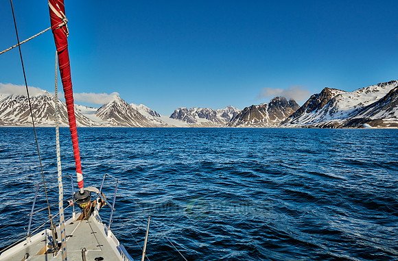 sail ship in front of landscape with mountains of Magdalenefjorden