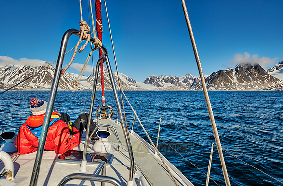 sail ship in front of landscape with mountains of Magdalenefjorden