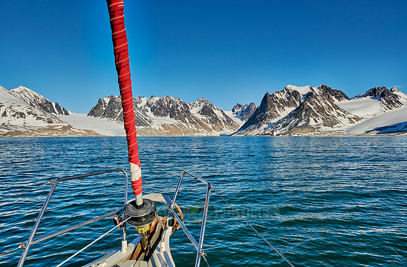 sail ship in front of landscape with mountains of Magdalenefjorden