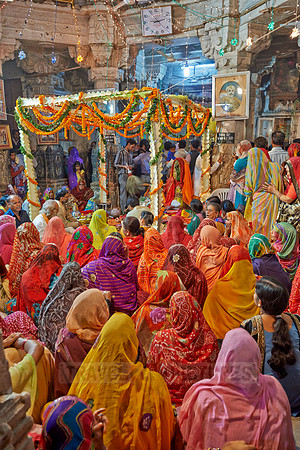 colorful hindu women during ceremony