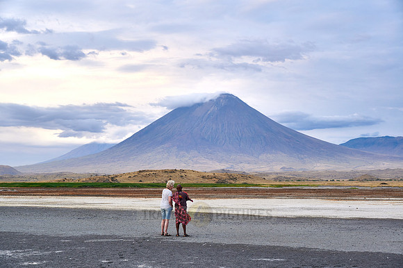 tourist and guide in front of Ol Doinyo Lengai vulcano