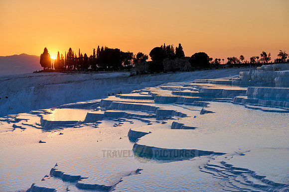 sunset behind Pamukkale travertine terraces
