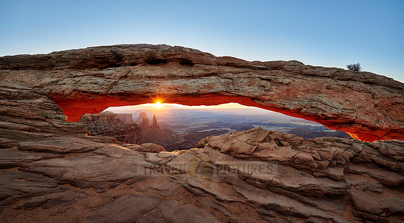 sun rises at Mesa Arch in Canyonlands National Park