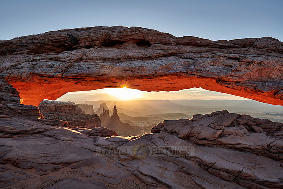 sun rises at Mesa Arch in Canyonlands National Park