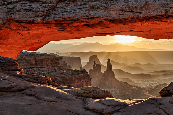 sun rises at Mesa Arch in Canyonlands National Park