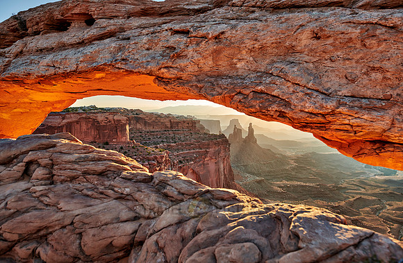 sun rises at Mesa Arch in Canyonlands National Park