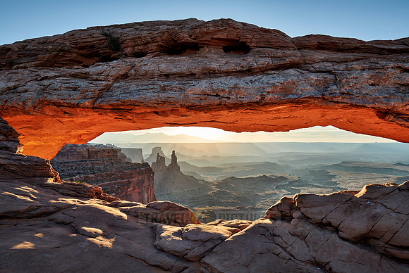sun rises at Mesa Arch in Canyonlands National Park